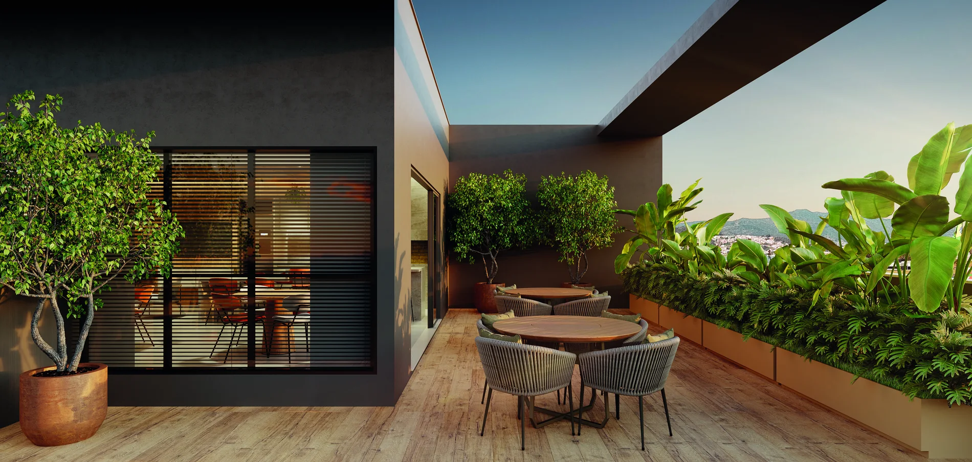 Terraço do rooftop do Unity, com área social mobiliada e vista para a cidade